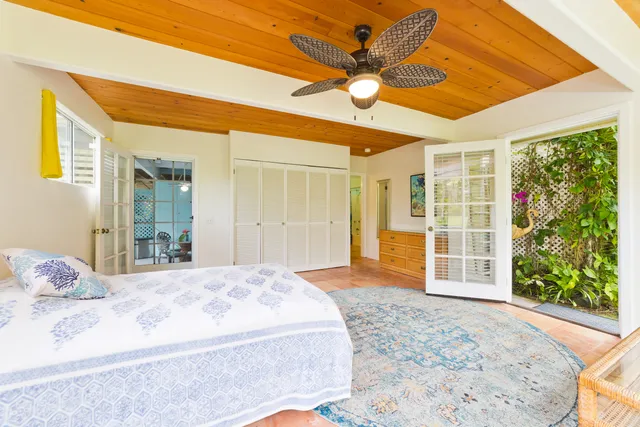 a bedroom with a bed and a large window