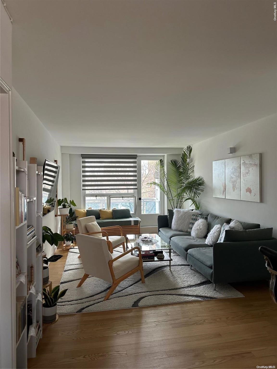 a living room with furniture window and a wooden floor