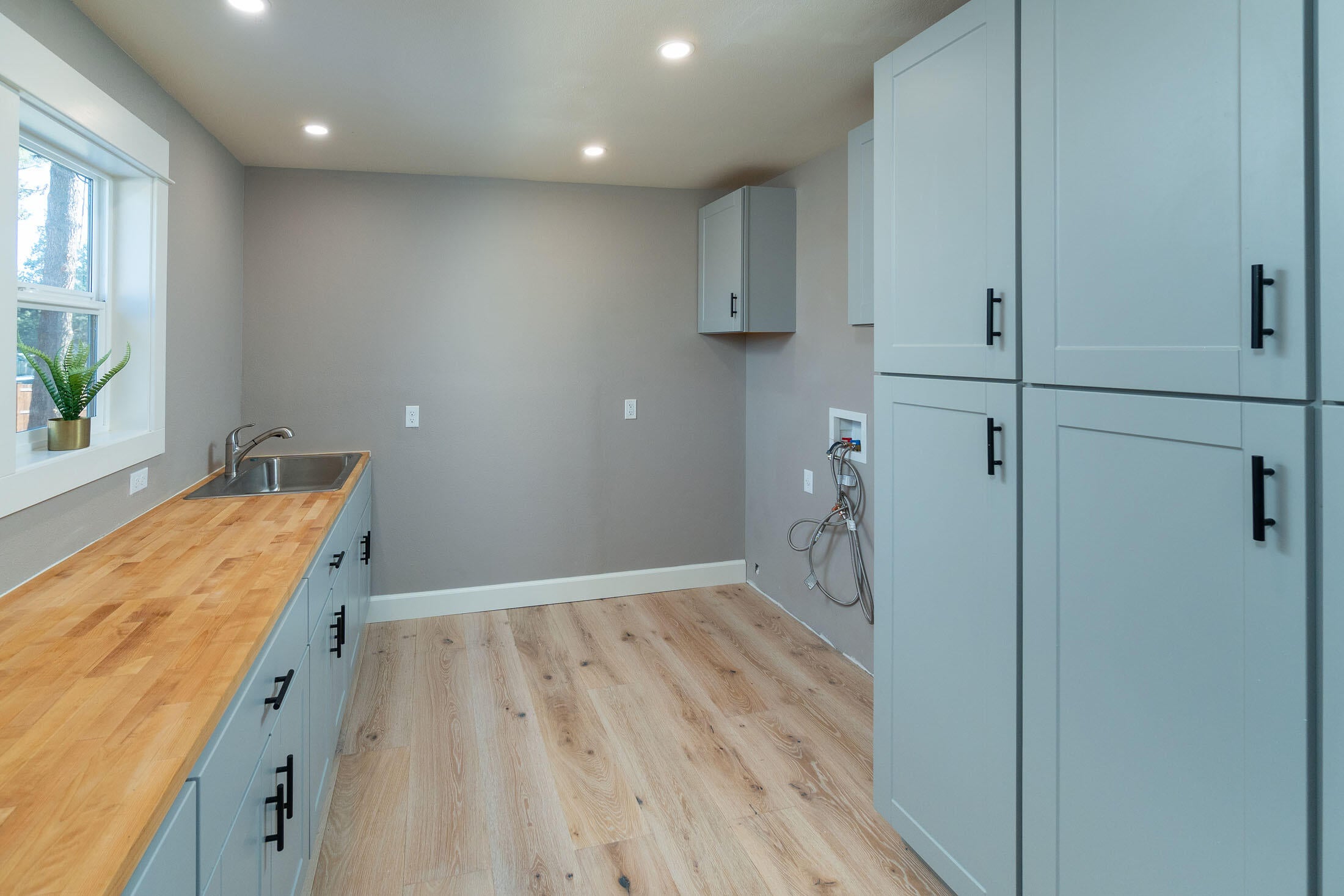 61151 Parrell Road Bend, OR 97702 - Photo 9 of 47 Newly renovated main level laundry room and pantry with custom built-ins and sink