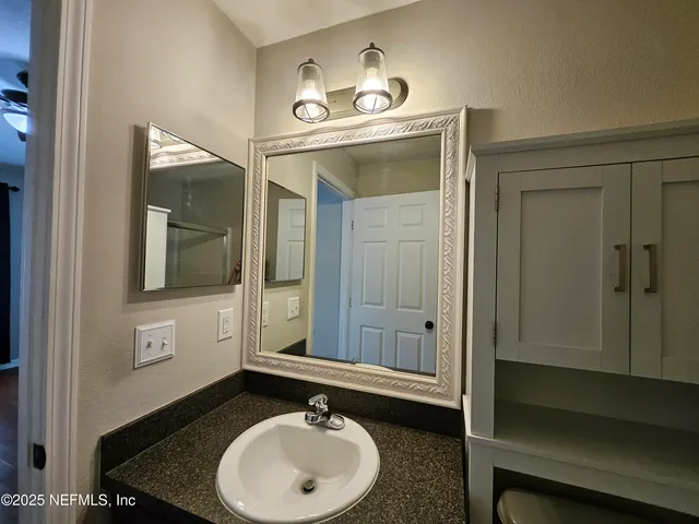 a bathroom with a sink and a mirror