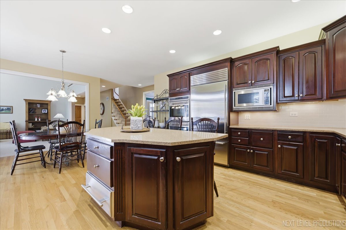 1914 North Ridge Avenue Arlington Heights, IL 60004 - Photo 14 of 50 a kitchen with stainless steel appliances granite countertop wooden cabinets a sink dishwasher a stove and a refrigerator