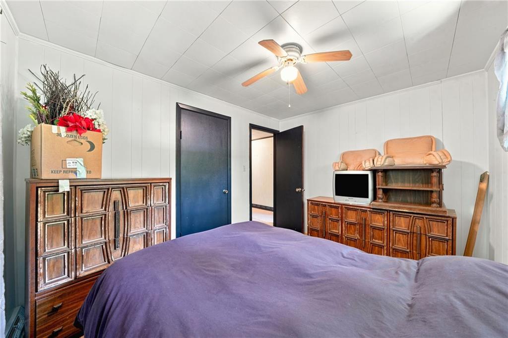 77 Spruce Peak Road Acme, PA 15610 - Photo 22 of 35 a bedroom with a bed and a flat screen tv