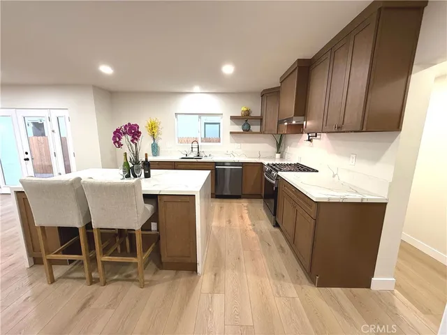 a kitchen with granite countertop a sink counter and chairs