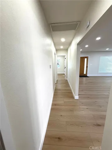 a hallway with wooden floor and entryway