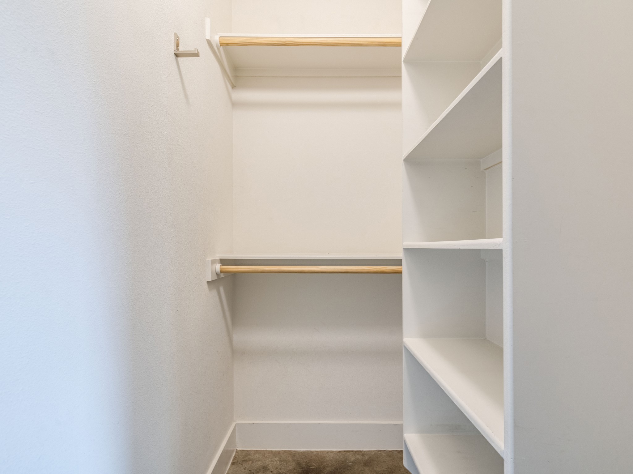 1404 Singleton Avenue, Unit B Austin, TX 78702 - Photo 15 of 21 Organized living begins here with this naturally illuminated walk-in closet, offering ample hanging space and integrated shelving.