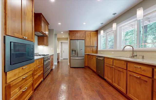 a bathroom with a granite countertop sink a mirror and a shower