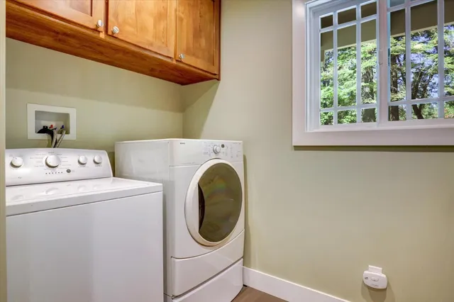 wooden floor fireplace and windows in an empty room