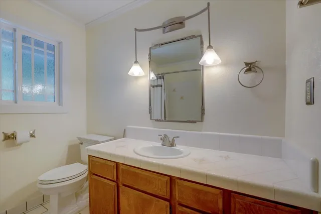 a front view of a house with a yard and tree s