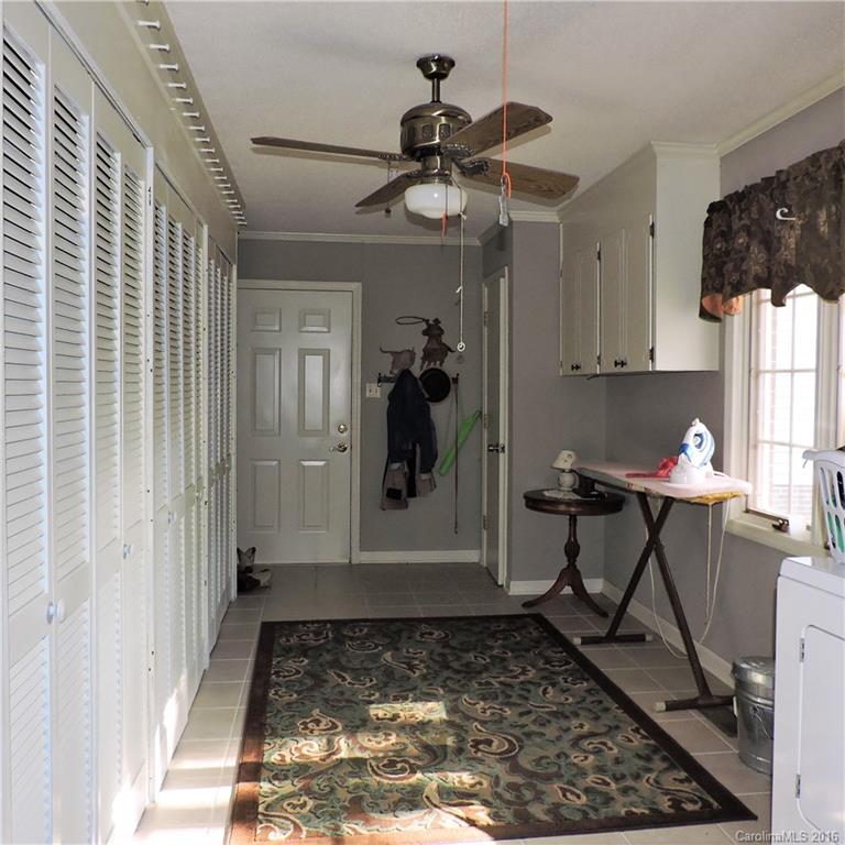 848 South Potter Road Lancaster, SC 29720 - Photo 2 of 24 a view of a hallway and a dining room with furniture and a rug