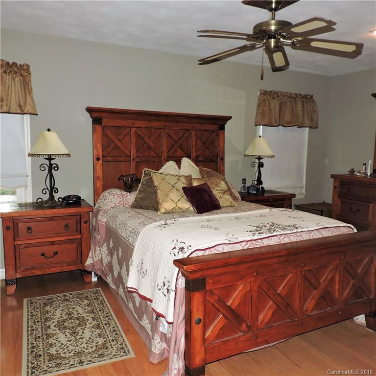 848 South Potter Road Lancaster, SC 29720 - Photo 15 of 24 a bedroom with a bed and a lamp on the dresser