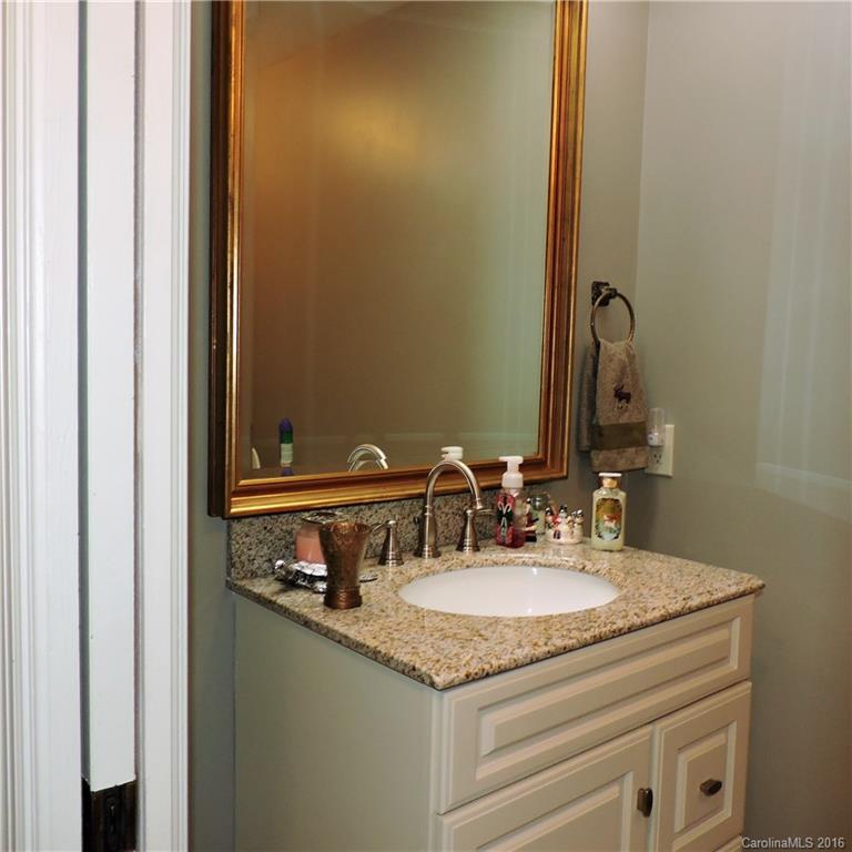 848 South Potter Road Lancaster, SC 29720 - Photo 20 of 24 a bathroom with a granite countertop sink and a mirror