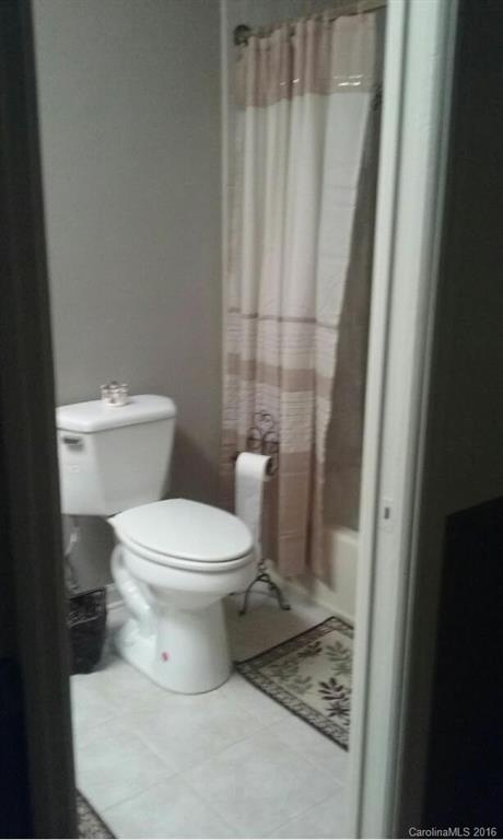 848 South Potter Road Lancaster, SC 29720 - Photo 24 of 24 a white toilet sitting next to a shower curtain
