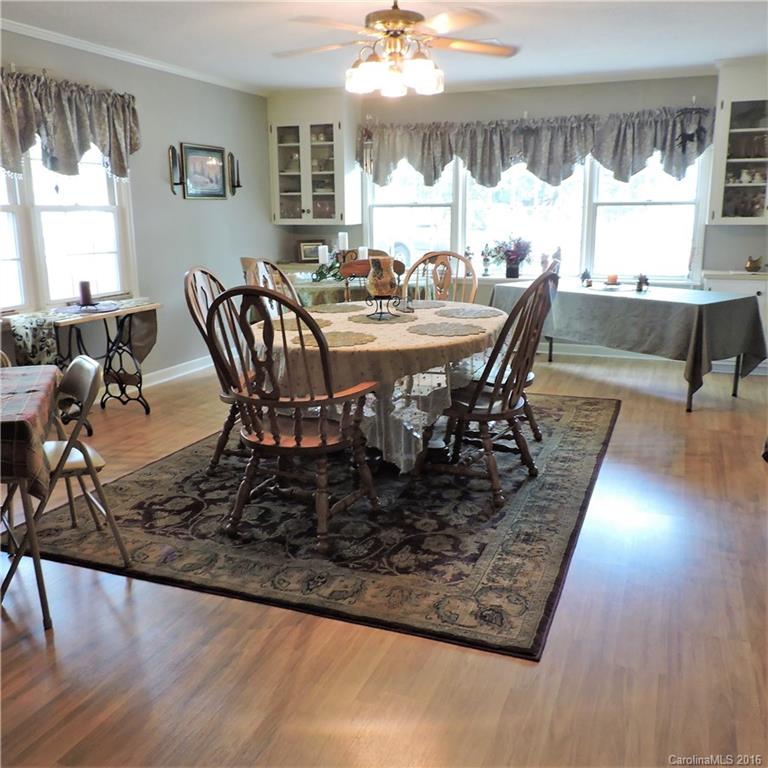 848 South Potter Road Lancaster, SC 29720 - Photo 4 of 24 a view of a dining room with furniture and wooden floor