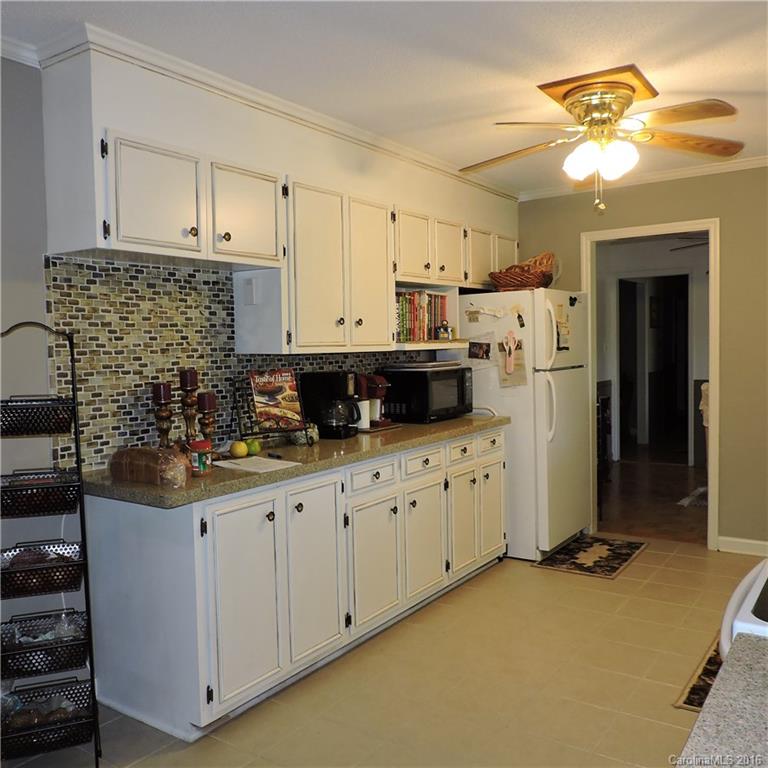 848 South Potter Road Lancaster, SC 29720 - Photo 9 of 24 a kitchen with stainless steel appliances granite countertop a stove a sink and a refrigerator