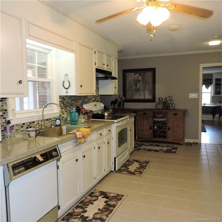 848 South Potter Road Lancaster, SC 29720 - Photo 10 of 24 a kitchen with stainless steel appliances a stove sink and cabinets