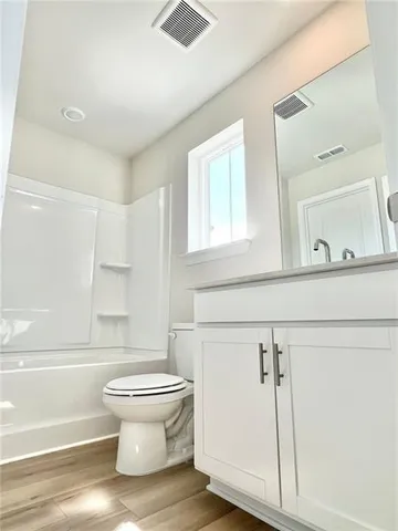a bathroom with a toilet and a mirror