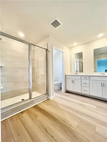 a spacious bathroom with a granite countertop sink and a mirror