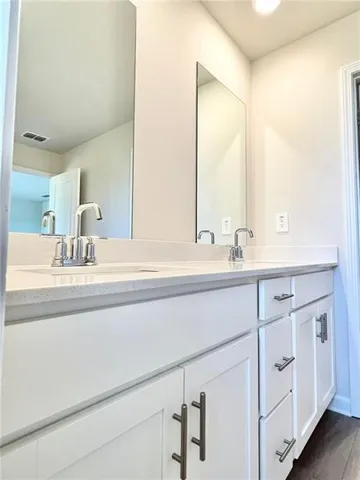 a bathroom with a double vanity sink and mirror