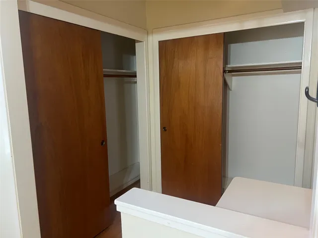 a bathroom with a granite countertop toilet sink and mirror