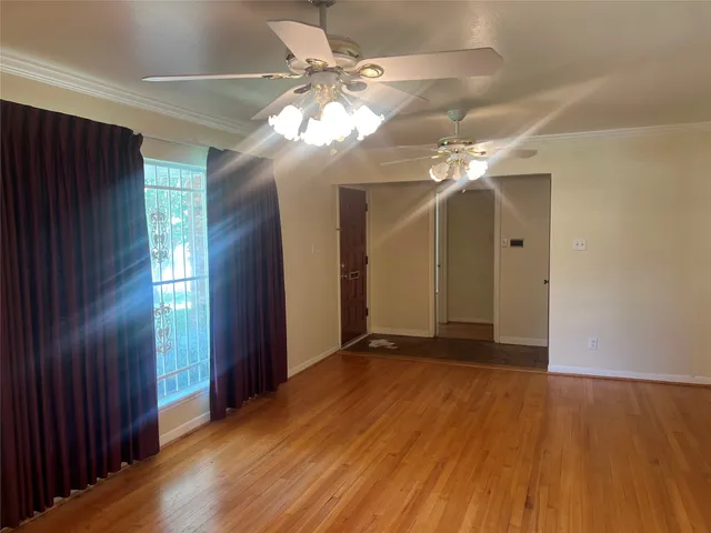 wooden floor in an empty room with a window
