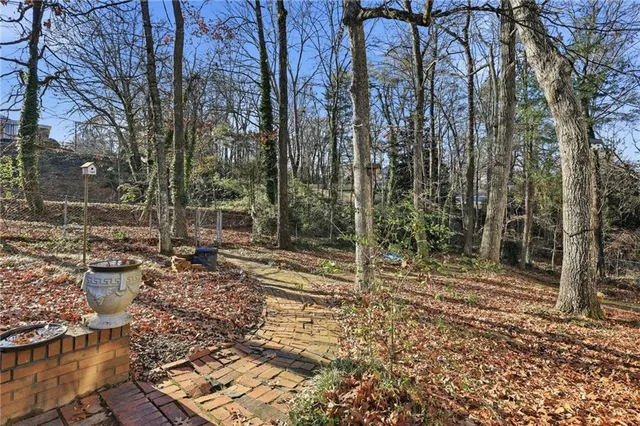 a view of a house with a yard and sitting area
