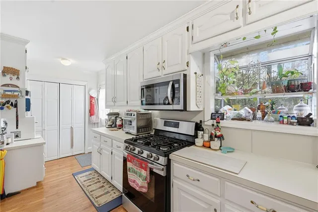a living room with furniture and kitchen view