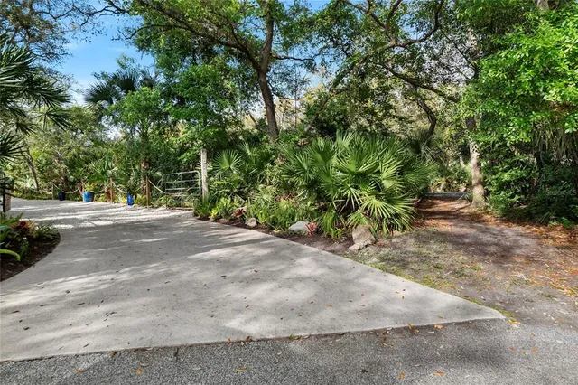 a view of a wooden deck with chairs and a yard
