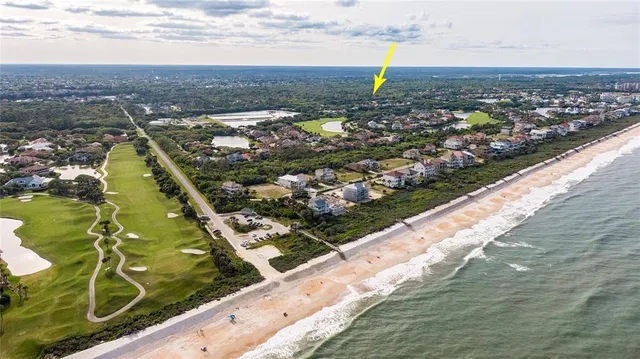 an aerial view of a house with garden space and street view