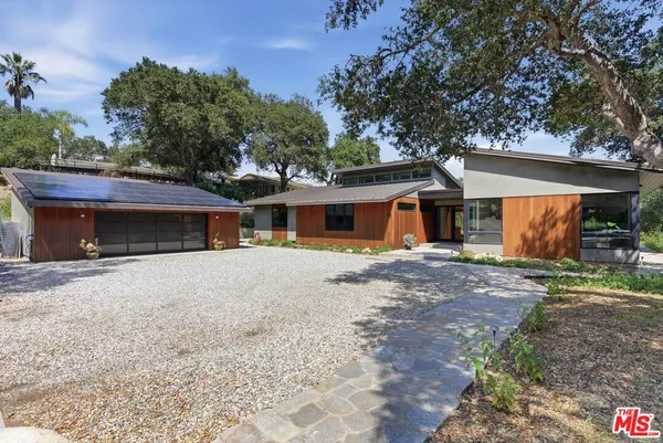 a front view of a house with a yard and a garage