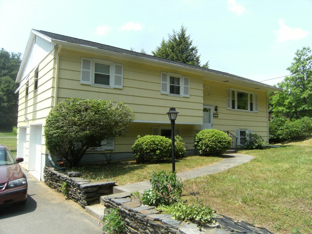 225 Huntington Road Russell, MA 01071 - Photo 1 of 20 a front view of a house with a yard