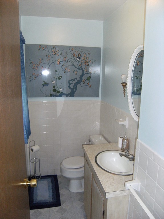 225 Huntington Road Russell, MA 01071 - Photo 10 of 20 a bathroom with a sink toilet and mirror