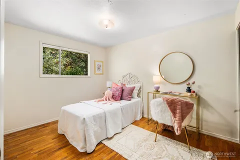 a bedroom with bed and a chandelier