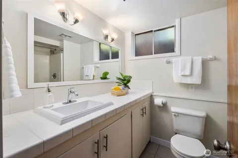 a bathroom with a toilet sink and mirror