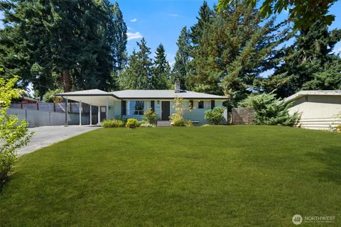 a front view of a house with a yard table and chairs