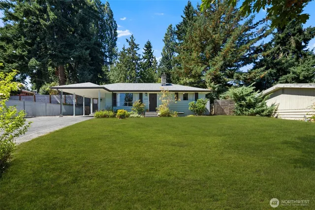 a front view of a house with a yard table and chairs
