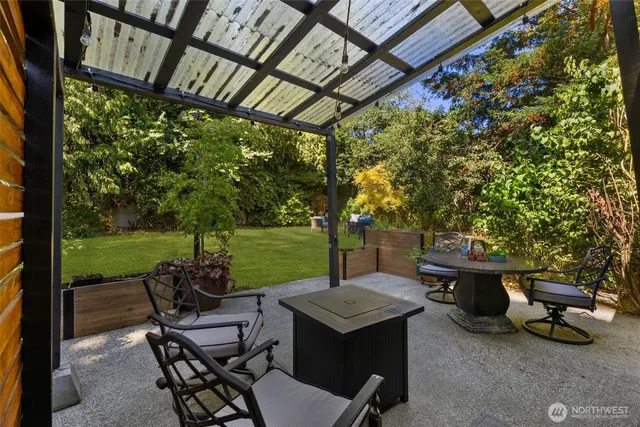 a view of a patio with table and chairs and potted plants