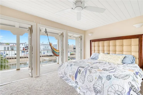 a bedroom with a large bed and a large window