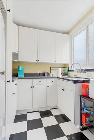 a kitchen with stainless steel appliances kitchen island granite countertop a sink and a cabinets