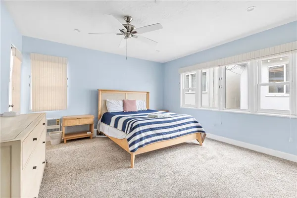 a spacious bedroom with a bed and a window