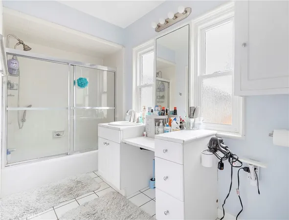 a spacious bathroom with a shower sink and mirror