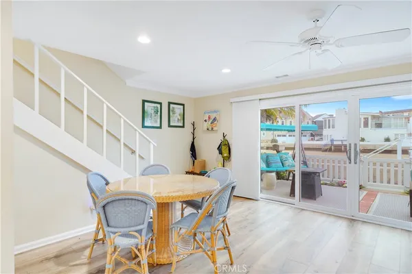 a dining room with furniture and wooden floor