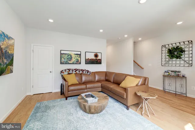 a living room with furniture a couch and kitchen view