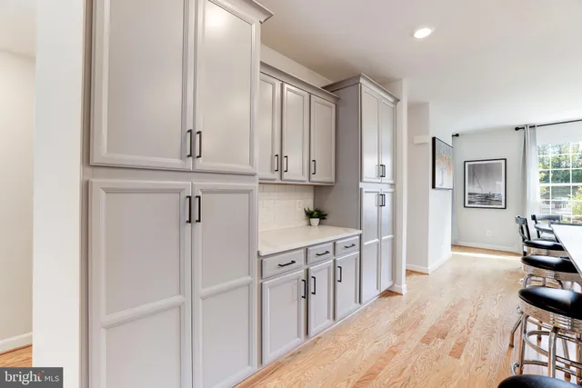 a kitchen with stainless steel appliances granite countertop a refrigerator and cabinets
