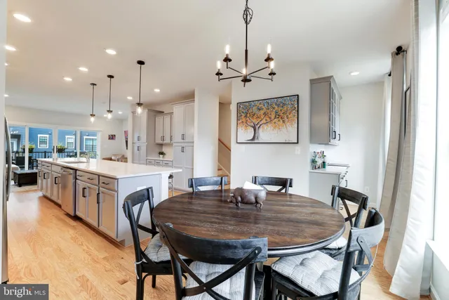 a large kitchen with kitchen island a table and chairs in it
