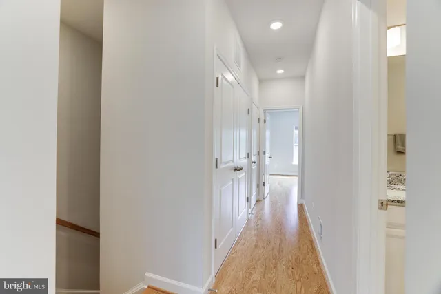 a view of a hallway with wooden floor