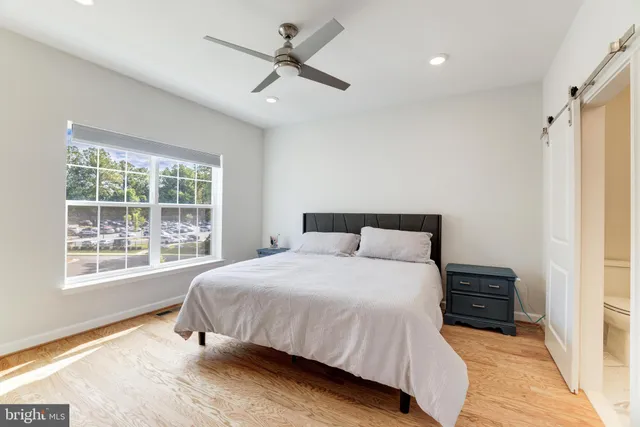 a bedroom with a large bed and a window