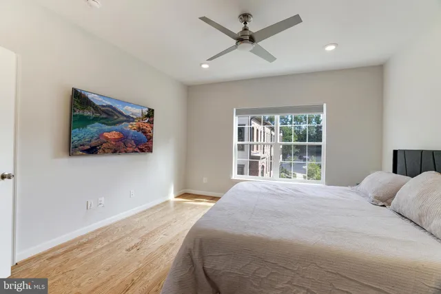 a bedroom with a large bed and a window