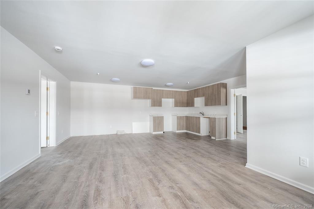 1030 Federal Road, Unit 204 Brookfield, CT 06804 - Photo 15 of 22 a view of a livingroom with wooden floor