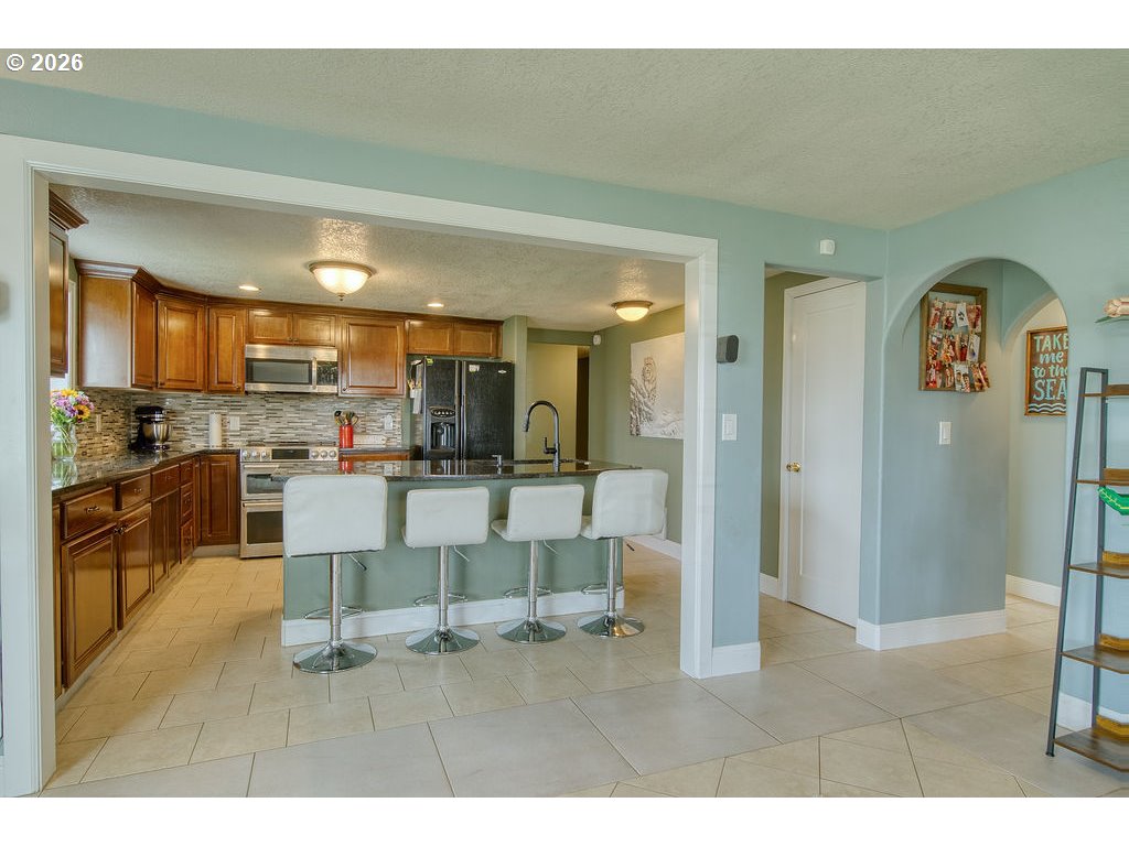 1045 Umatilla Street St. Helens, OR 97051 - Photo 14 of 43 a living room with stainless steel appliances kitchen island granite countertop furniture and a view of kitchen