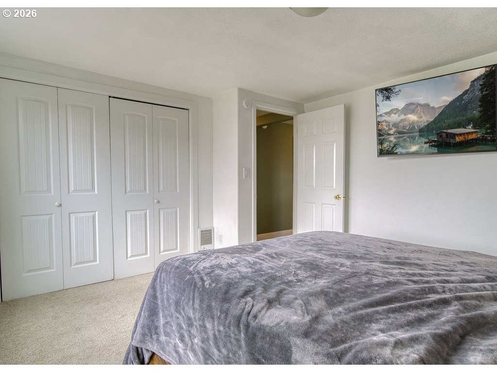1045 Umatilla Street St. Helens, OR 97051 - Photo 17 of 43 a bedroom with a bed and painting on the wall